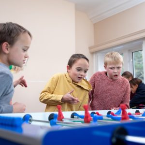 boys playing foosball