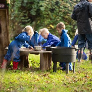students cooking together outside