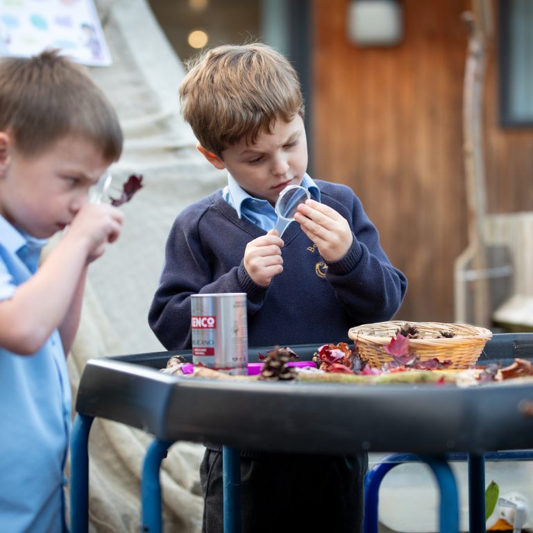 students using magnifying glasses