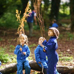 3 children holding branches