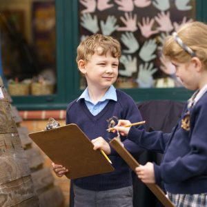 pupils holding clipboards