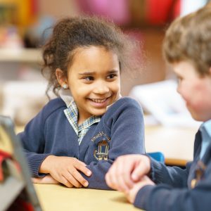 Student smiling at her peer