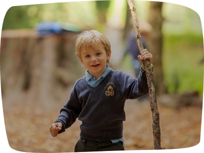 boy holding a branch