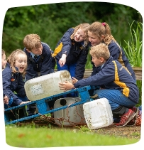 children adding water buts to a pallet