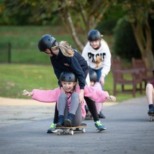 girls learning to skateboard