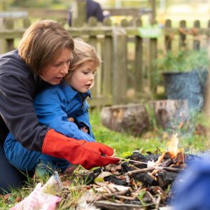 student watching how marshmallows can be cooked in the fire