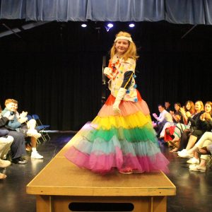 a student dressed up in a dress for a fashion show
