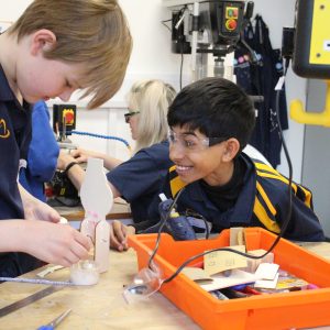 2 students working on a small project involving electronics