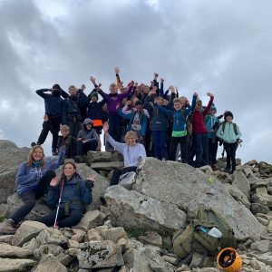 big group of students at the top of a mountain