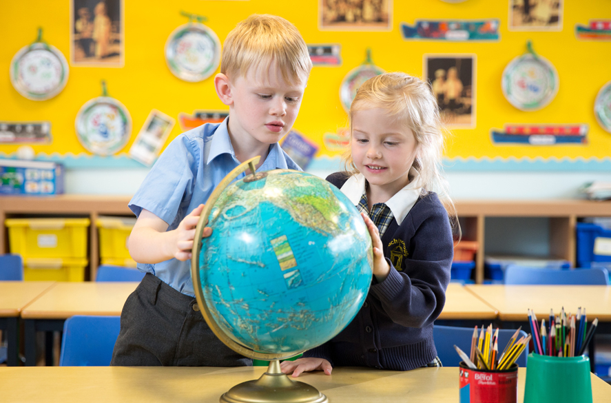 students using the globe to learn