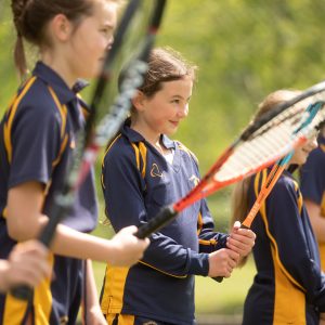 children holding tennis rackets