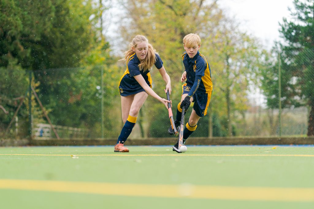 2 students playing hockey