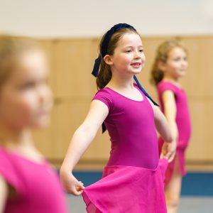 3 students in pink ballerina outfits