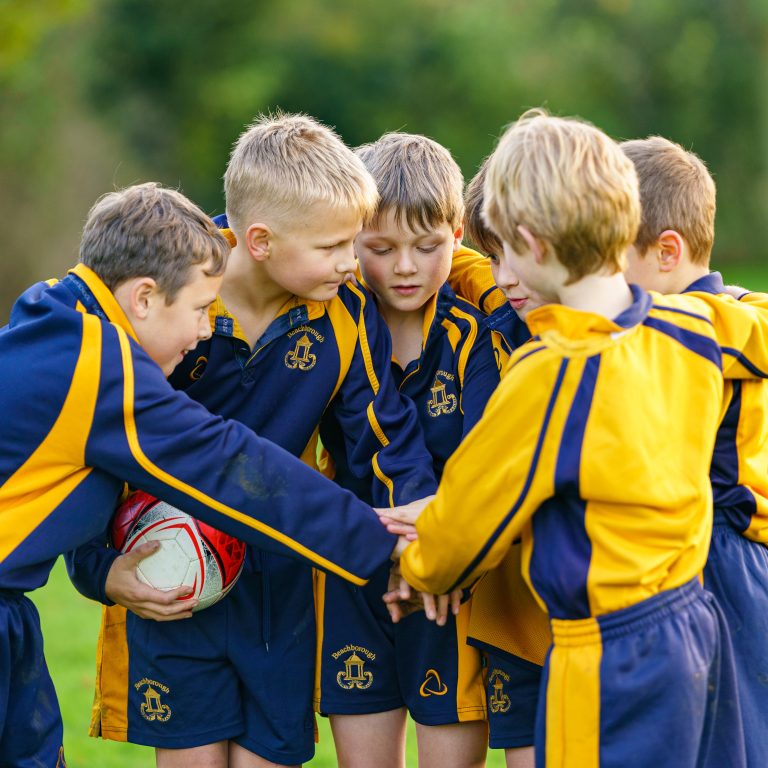 students huddled together for a team meeting