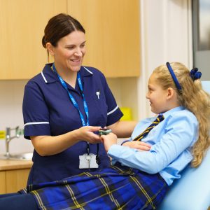 student having her pulse checked