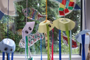 creative jellyfish hanging in the window of wraparound care, made out of cupcake papers