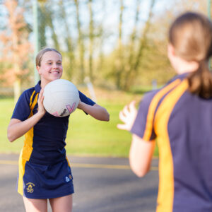 girls playing netball on netball courts at Beachboough Prep