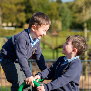 two children using climbing equipment in nursery outdoor space