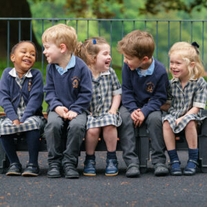 children sitting showing Beachborough prep uniform for reception class