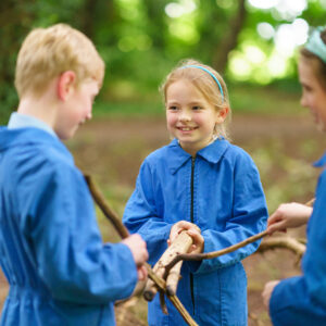 outdoor learning. Children in boiler suits in Beachborough woods.