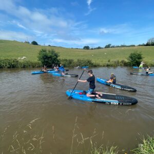 children paddle boarding during beachborough prep year 7 trip